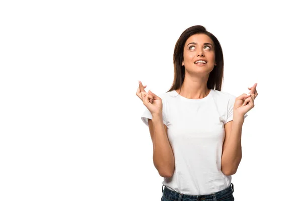 Cheerful woman in white t-shirt holding fingers crossed, isolated on white — Stock Photo