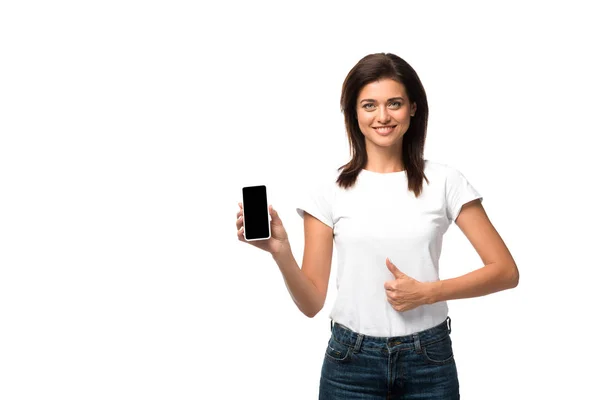 Красива молода жінка показує великий палець вгору і смартфон з порожнім екраном, ізольовані на білому — стокове фото