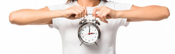 Cropped view of woman holding alarm clock in hands, isolated on white — Stock Photo