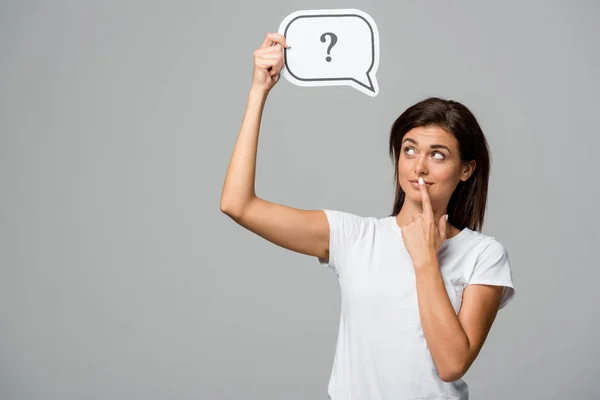 Thoughtful woman holding speech bubble with question mark, isolated on grey — Stock Photo