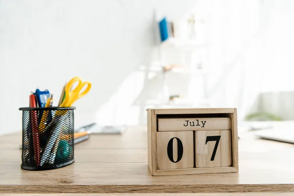 Close up of wooden calendar on table in light modern office — Stock Photo