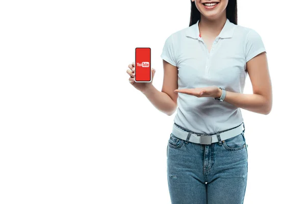 KYIV, UKRAINE - JULY 15, 2019: cropped view of happy brunette asian woman presenting smartphone with youtube app isolated on white — Stock Photo