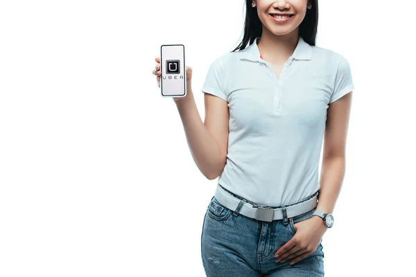 KYIV, UKRAINE - JULY 15, 2019: cropped view of smiling brunette asian woman holding smartphone with uber app isolated on white — Stock Photo