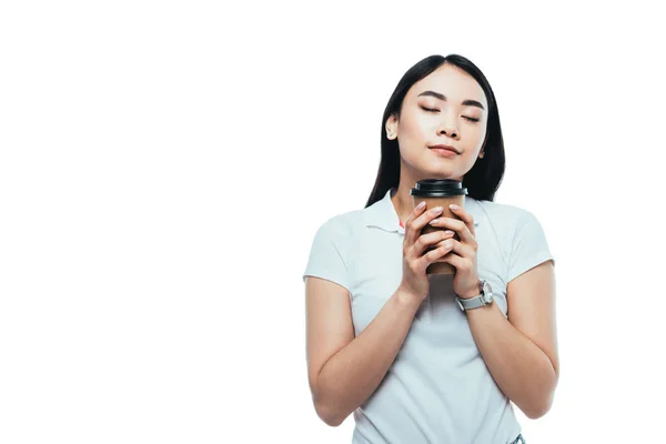 Attractive asian girl with closed eyes holding paper cup isolated on white — Stock Photo