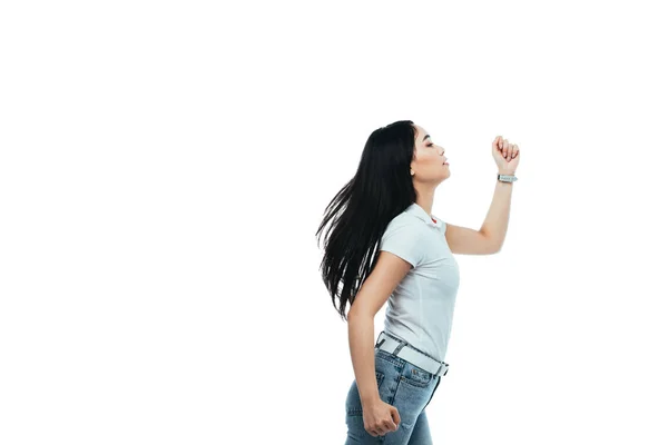 Side view of attractive asian girl running away isolated on white — Stock Photo
