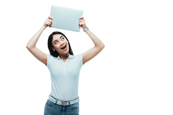 Animado asiático menina segurando laptop isolado no branco — Fotografia de Stock