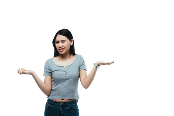 Upset attractive asian girl showing shrug gesture isolated on white — Stock Photo