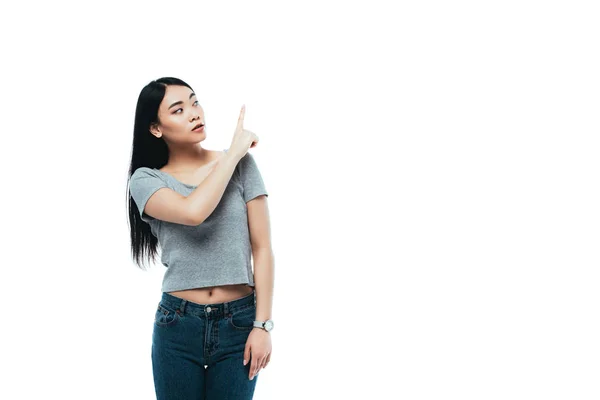 Asian girl pointing with finger isolated on white — Stock Photo