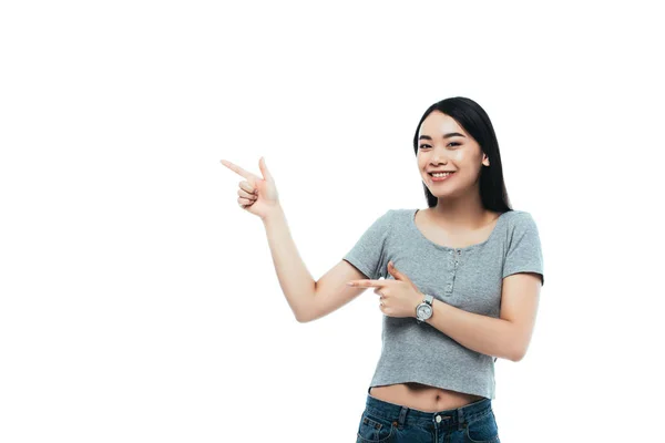 Feliz menina asiática apontando com os dedos isolados no branco — Fotografia de Stock