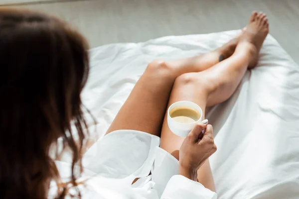 Selective focus of woman holding cup of coffee at morning — Stock Photo