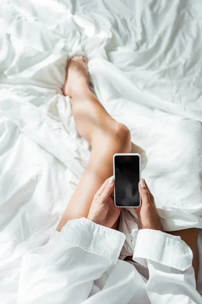 Cropped view of woman holding smartphone with copy space at morning — Stock Photo