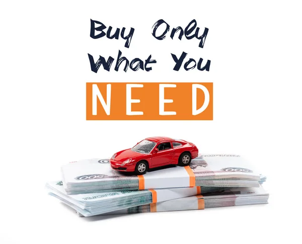 Money and red toy car with buy only what you need illustration isolated on white — Stock Photo