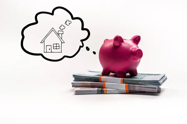 Pink piggy bank on stack of russian rubles on white background with house in thought bubble illustration — Stock Photo