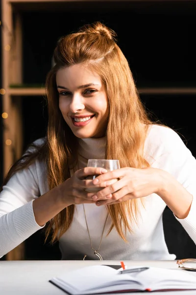 Schöne lächelnde Frau mit einem Glas Kaffee im Café — Stockfoto