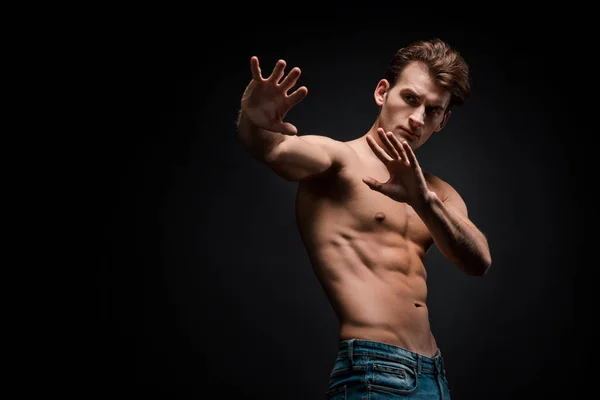 Sexy shirtless man posing isolated on black — Stock Photo