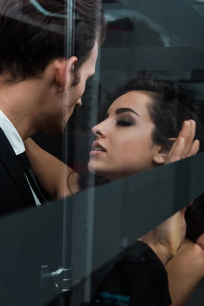 Beautiful passionate couple hugging and flirting in lift — Stock Photo
