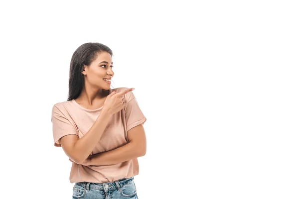 Smiling african american woman looking away and pointing with finger isolated on white — Stock Photo