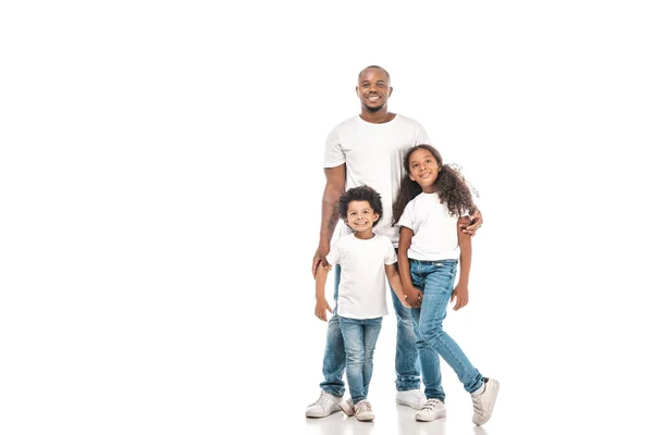 Feliz afroamericano padre, hermana y hermano sonriendo a la cámara sobre fondo blanco - foto de stock