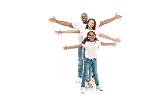 Cheerful african american family imitating flying with outstretched hands on white background — Stock Photo