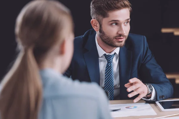 Selective focus of handsome businessman talking at business meeting — Stock Photo