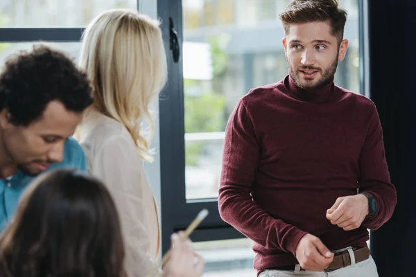 Young businessman looking at businesswoman at business meeting — Stock Photo