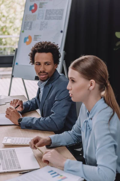 African american businessman looking at attractive colleagues during business meeting — Stock Photo