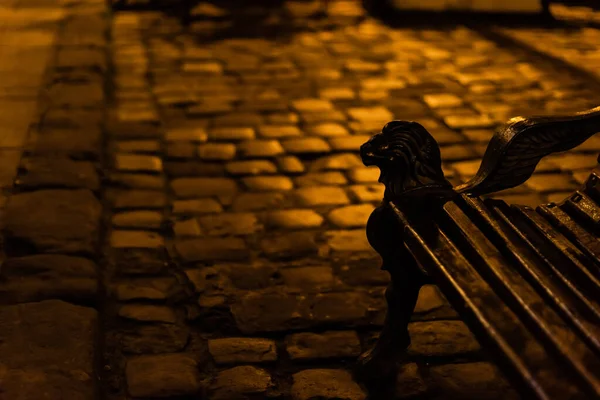 Selective focus of bench near lighting on paving stones — Stock Photo