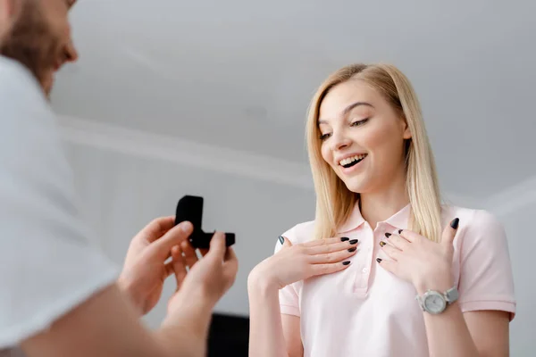 Selective focus of bearded man making proposal to excited girl — Stock Photo