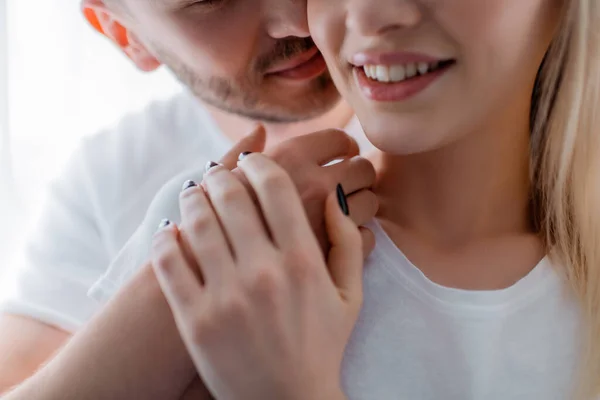 Cropped view of man touching smiling girl at home — Stock Photo