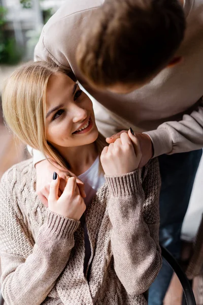 Selective focus of man holding hands with cheerful woman outside — Stock Photo