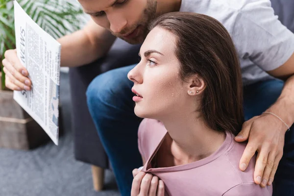 Exhausted young couple suffering from summer heat at home — Stock Photo