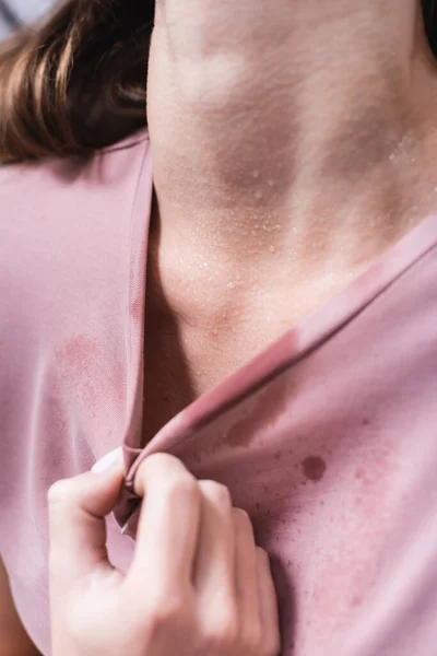 Cropped view of sweaty girl suffering from heat at home — Stock Photo