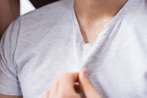 Cropped view of sweaty man suffering from summer heat — Stock Photo