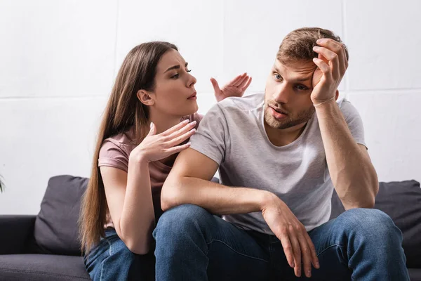 Young couple suffering from heat at home — Stock Photo