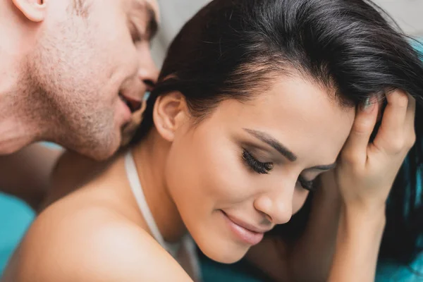 Side view of handsome man kissing neck of beautiful woman — Stock Photo