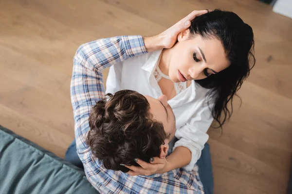 Overhead view of man embracing sensual girlfriend at home — Stock Photo