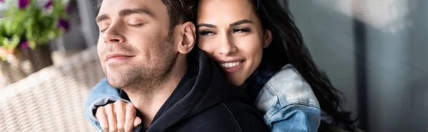 Beautiful smiling woman embracing boyfriend on terrace, panoramic shot — Stock Photo