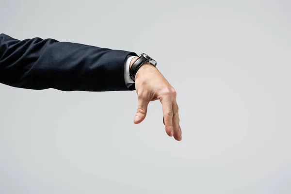 Cropped view of businessman manipulating with hand isolated on grey — Stock Photo