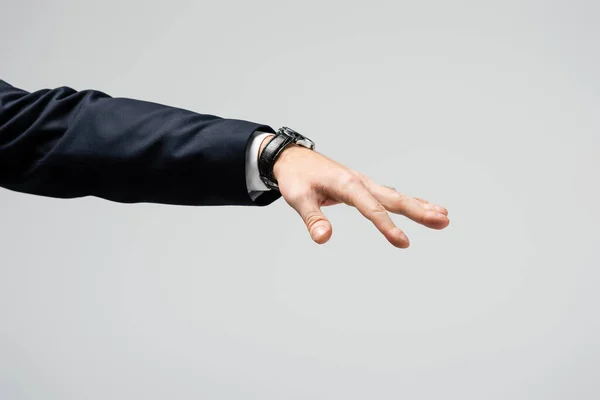 Cropped view of businessman manipulating with hand isolated on grey — Stock Photo