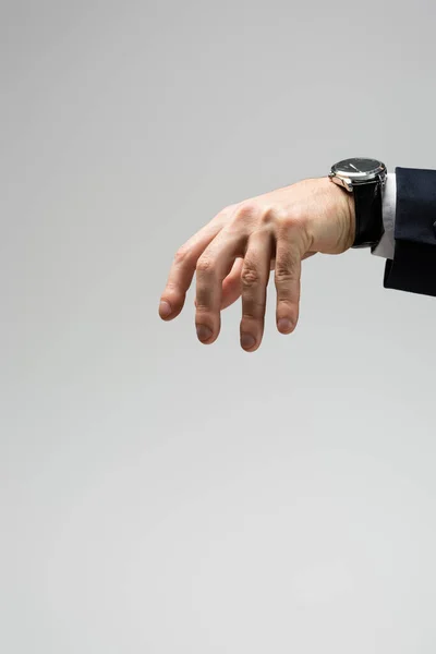 Abgeschnittene Ansicht eines Geschäftsmannes, der mit der Hand manipuliert, isoliert auf grau — Stockfoto