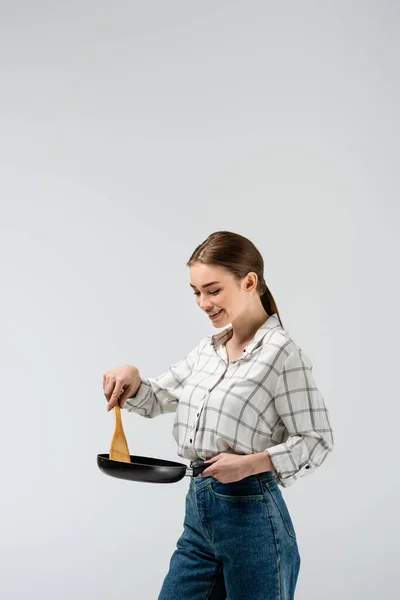 Attractive girl posing like puppet with mop and frying pan isolated on grey — Stock Photo