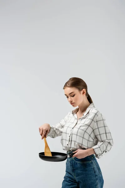 Attractive girl posing like puppet with mop and frying pan isolated on grey — Stock Photo