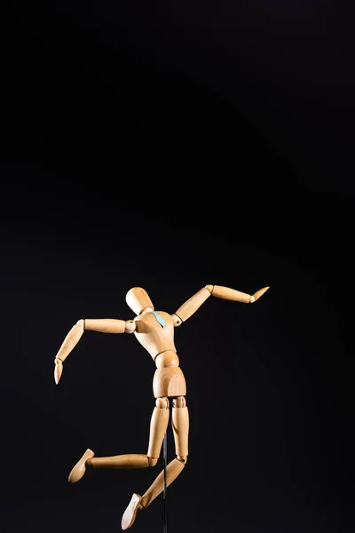 Wooden marionette in tie isolated on black — Stock Photo