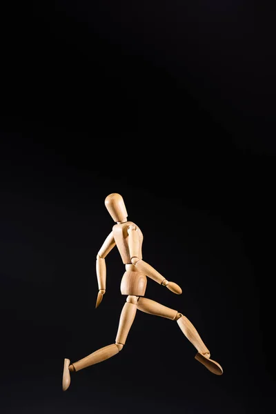 Wooden marionette posing isolated on black — Stock Photo