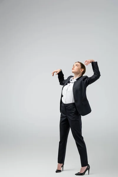 Businesswoman marionette in suit posing isolated on grey — Stock Photo