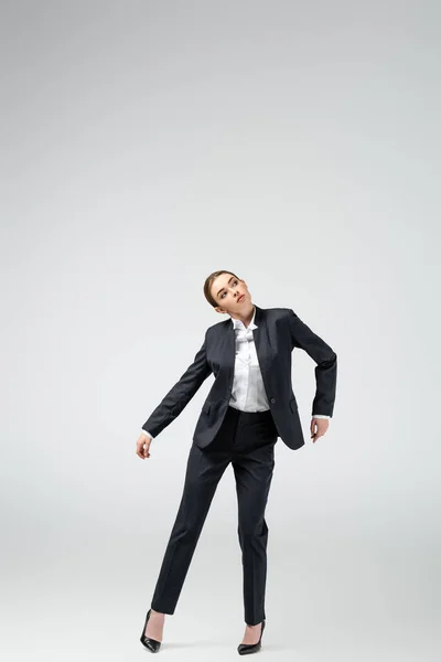 Businesswoman marionette in suit posing isolated on grey — Stock Photo