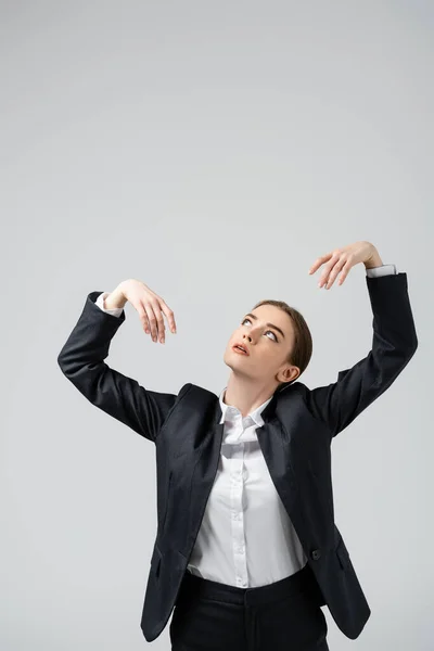Businesswoman marionette in suit posing isolated on grey — Stock Photo