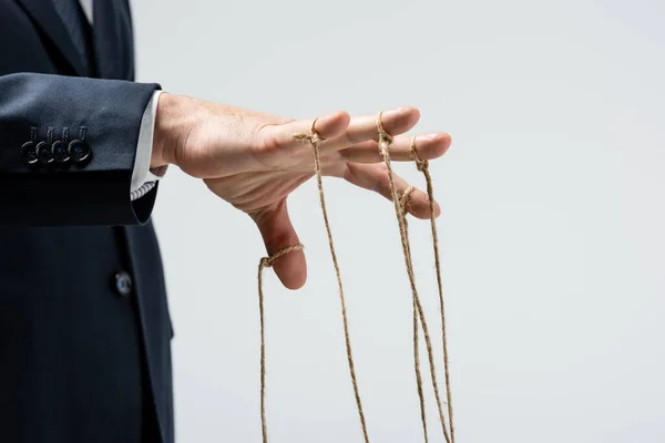 Cropped view of puppeteer with strings on fingers isolated on grey — Stock Photo