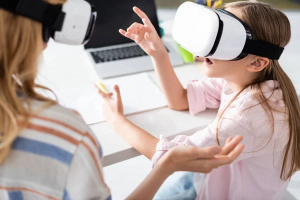 Selective focus of mother and excited kid using vr headsets at home — Stock Photo