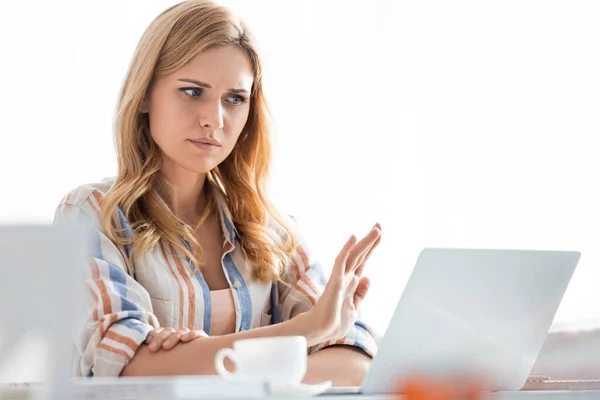 Selective focus of confused woman showing stop gesture — Stock Photo